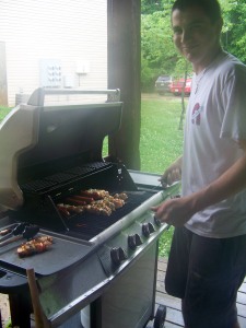 Ben cooks the chicken kabobs, hotdogs, & Brats